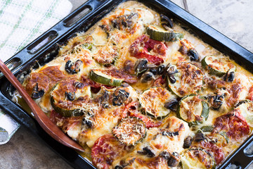 Baked chicken breasts with zucchini, tomatoes, mushrooms, cheese