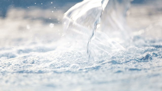 blue water slowly running into the swimming pool