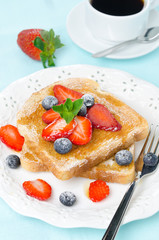 crispy toast with honey, fresh strawberries and blueberries