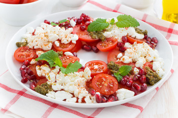 Italian salad with cherry tomatoes, cottage cheese, mint pesto