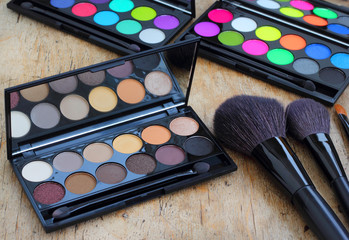 Makeup brushes make-up eye shadows vintage wooden background