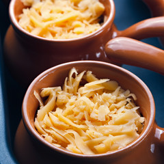 Roast with vegetables, meat and cheese in pottery.