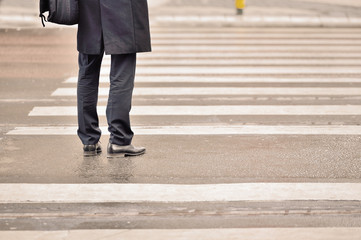 Person waiting on zebra crossing