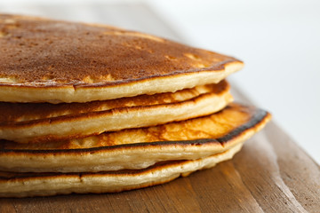 Fried pancakes on a wooden surface.