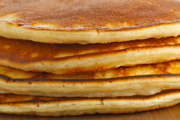 Fried pancakes on a wooden surface.
