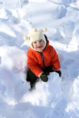 Toddler plays with snow