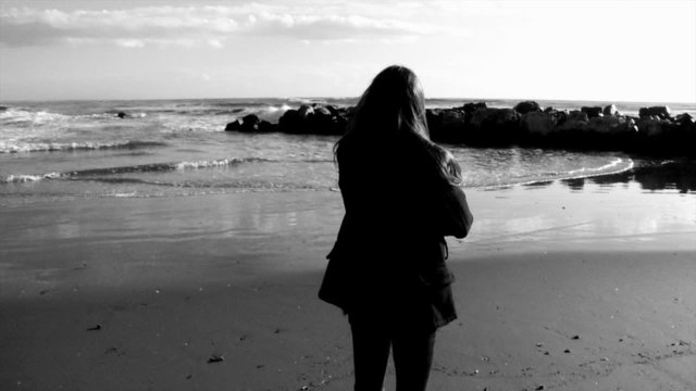 Young teenager looking the beach black and white
