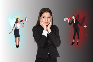 Young businesswoman making choice between good and bad