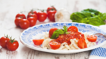 Healthy plate of Italian spaghetti topped with a tasty tomato an