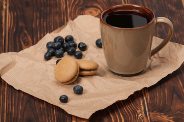 Macaroon Biscuits, Blueberries On Paper. Wooden Table
