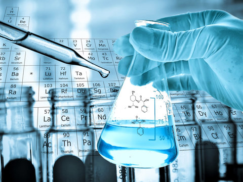 flask in scientist hand with laboratory background