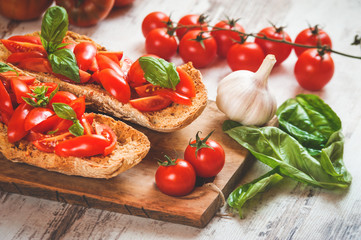 Italian starter, bruschetta with Sicilian red fresh tomato on a