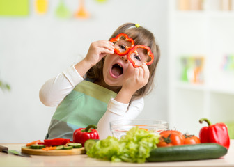 kid girl having fun with food vegetables - 78311795