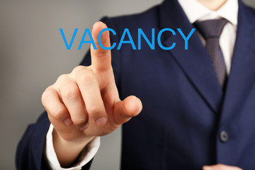 Businessman hand pushing Vacancy sign
