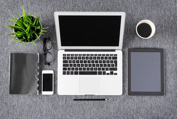 Creative professional's work items and tech gadgets from above