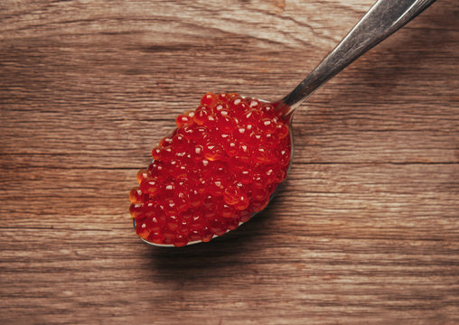 Red salmon caviar on a spoon