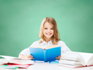happy student girl reading book at school