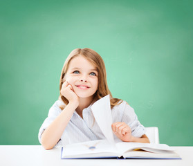 happy student girl with book at school