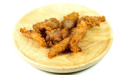 Pork fried on wooden dish, isolated on a white background