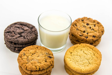 variety of cookies and glass of milk