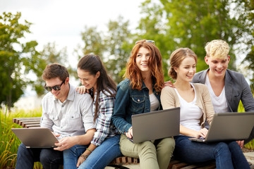 students or teenagers with laptop computers
