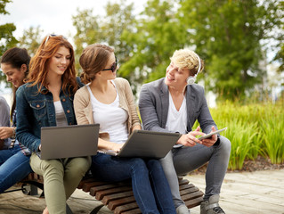 students or teenagers with laptop computers