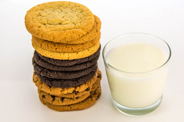 Fototapeta na wymiar variety of cookies stacked and glass of milk