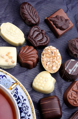 various chocolate candies with tea