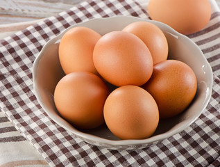 Fresh  raw brown eggs in a bowl.
