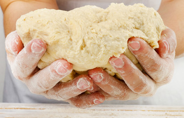 Hands holding a  dough