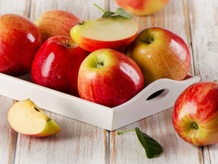 Fresh apples  in white box on a wooden table