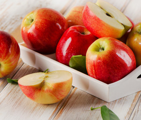 Fresh apples  in white box on  wooden table