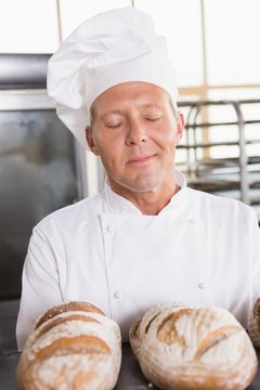 Baker smelling freshly baked breads