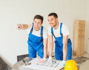 group of builders with blueprint