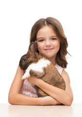 Fototapeta premium Little girl holding cute brown bunny