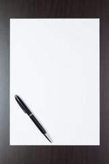 blank sheet of paper on the table with a pen