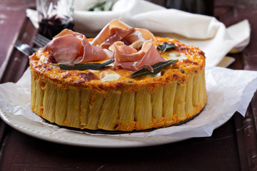 Pasta pie with cheese sauce and sage