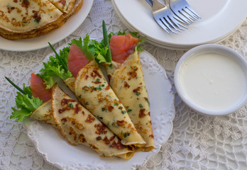 Thin rolled pancakes, crepes with salmon, . Traditional Russian