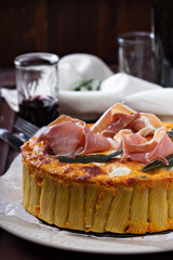 Pasta pie with cheese sauce and sage