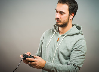 Young man with video game controllers