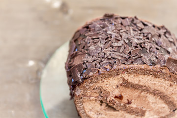 Chocolate cake slice on a transparent plate