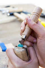 Stonesetting a rough amazonite gemstone using a ring clamp and a burnishing   tool