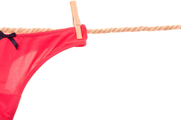 red panties hanging on a rope clothesline