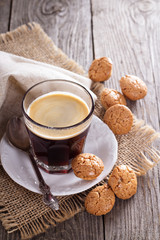 Black coffee in a glass with almond cookies