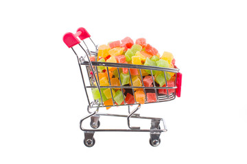 a bunch of candied fruits in a shopping trolley
