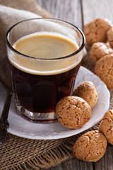 Black coffee in a glass with almond cookies