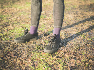 Legs oand feet of person standing on the grass