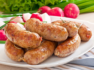 Homemade sausages baked in the oven and salad