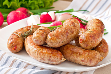 Homemade sausages baked in the oven and salad