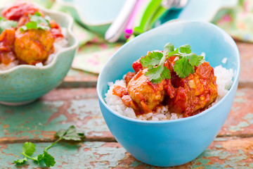 meat balls in tomato sauce and rice.